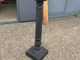an image of a black pedestal with a clock on top of it