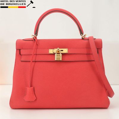 Sac à main Hermès en cuir rouge corail avec des finitions dorées