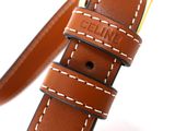 leather watch strap with white stitching and a gold buckle