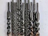 a bunch of drill bits sitting on top of each other