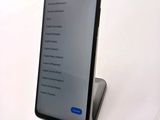 a close up of a cell phone on a stand on a table