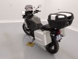 a motorcycle that is parked in a room with white walls