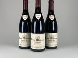 trois bouteilles de vin rouge posées sur une table