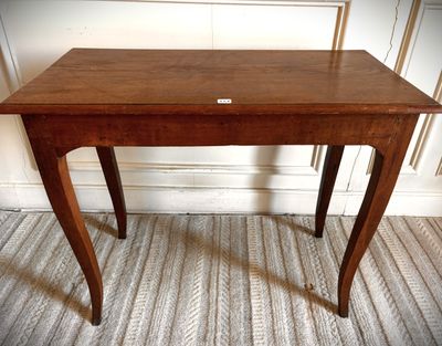 a small wooden table with a label on it
