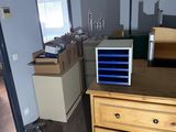 a room with a dresser and a vacuum in it