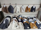 many hats and mittens on display in a store