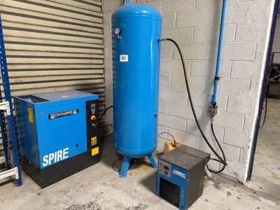 a large blue tank and a small blue machine in a garage