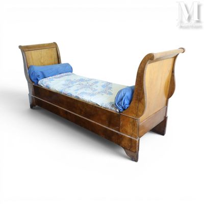 a wooden bed with a blue pillow on top of it