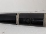 a black and silver pen laying on top of a white surface