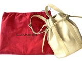 a close up of a purse and a red bag on a white surface