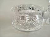 a glass jar with a lid and a spoon on a table