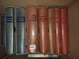 five books in a box on a shelf