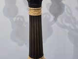 a black and gold vase on a wooden table