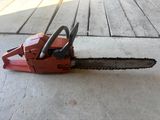 a chainsaw sitting on the ground on the floor