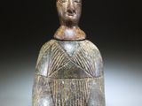 l'image d'une statue d'un homme avec un chapeau sur la tête