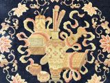 an image of a blue area rug with a floral design on it