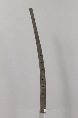 a glass vase with a knife in it on a table