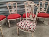 four chairs with red cushions in front of a garage door