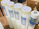 many rolls of white paper sitting on a table