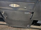 a stainless steel counter top with a metal drawer underneath it