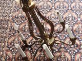 an antique brass chandelier with five lights on a blue carpet