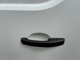 a close up of a door handle on a white car