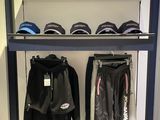a rack with hats and jackets on it in a room
