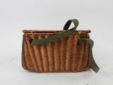 an old wicker basket with a green ribbon tied around it