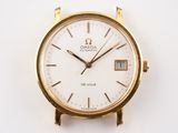 a gold watch with a white face on a white surface