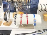 many bracelets on display on a table in a store