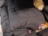 a pile of clothes on a shelf in a room
