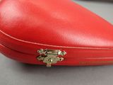 a red case with a lock on it on a table
