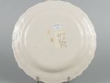 underside view of a white plate with chinese writing on it