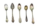 five spoons and a fork sitting next to each other
