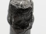 a close up of a bottle of wine with a green label on it