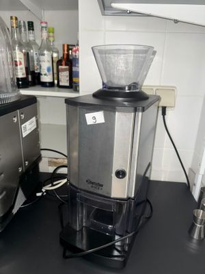 a coffee grinder sitting on a counter in a kitchen