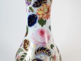 a vase with a floral design on it on a white background