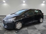 a black car is parked on a checkered floor in a garage