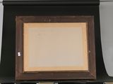 an old picture frame sitting on top of a shelf next to a wall