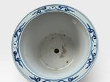 a blue and white bowl on a white surface