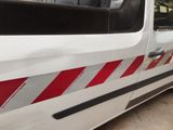 a white van with a red and white stripe on the side of it