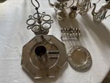a silver plate with a candle holder and a silver plate with a silver plate and a silver plate with a silver plate and a silver plate with a silver