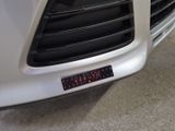 a close up of a car ' s front grill with a sticker on it