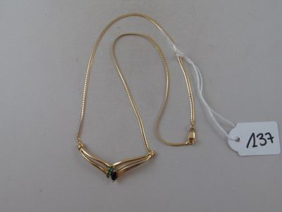 gold plated necklace with a green stone on a white background