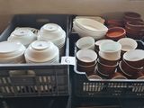 many cups and containers that are sitting on a table