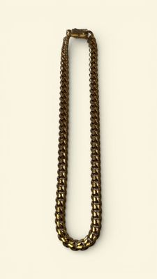 a close up of a necklace on a white surface
