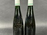 two bottles of wine sitting next to each other on a table