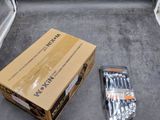 a box of screws sitting on the floor next to a box of screws