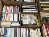 many boxes of books that are stacked on top of each other
