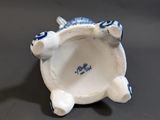 porcelain figurine of a blue and white turtle on a black surface
